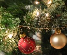 Holiday lights and ornaments on a tree.