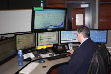 Dispatcher sitting in front of computer displays.