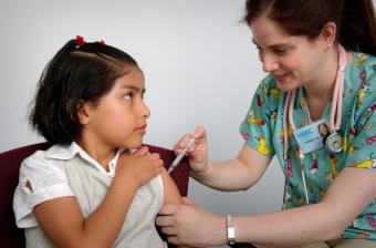 Child receiving immunization in arm