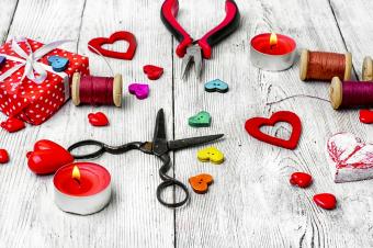 Packing holiday gifts for Valentine's day. Thread, button and symbolic heart.