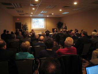 Attendees watching and listening to an presentation.